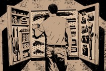 A man in a shadowy room reaching into a wall-mounted gun cabinet