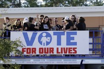 Students dance atop a bus.