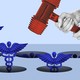 a pair of grayscale hands hold a red plastic mallet and aim at blue medical symbols popping up from holes
