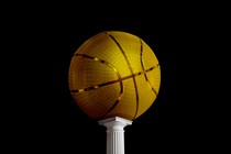 A golden basketball on a pedestal