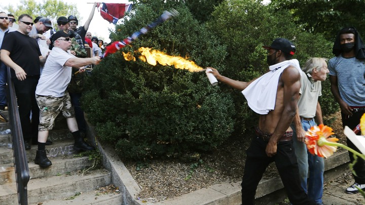 Corey Long sprays a makeshift flamethrower at white nationalist demonstrators