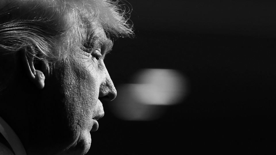 Black-and-white photograph of Donald Trump in profile from the right, with the background out of focus
