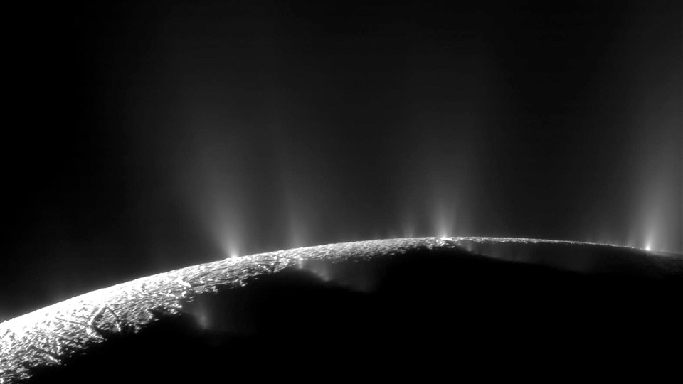 A spacecraft image of the south pole of Enceladus, Saturn's icy moon, spewing water vapor into space through cracks in its frigid surface