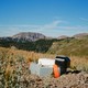 A mountain range with a small hexagonal silver node in the foreground