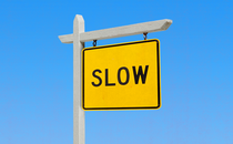 An illustration of a yellow "For Sale" sign that reads: "Slow"