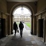 People walk into the quadrant of Clare College at Cambridge University in eastern England October 23, 2010.
